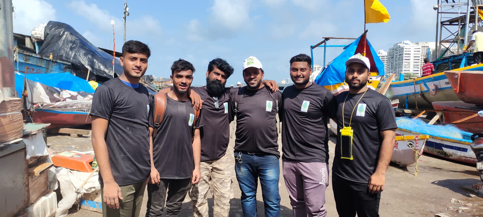 Disaster management team conducting beach cleaning drive for environmental conservation